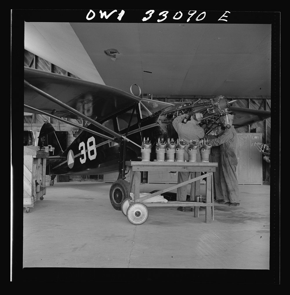 Bar Harbor, Maine. Civil Air Patrol base headquarters of coastal patrol no. 20. Replacing the cylinders in a plane after…