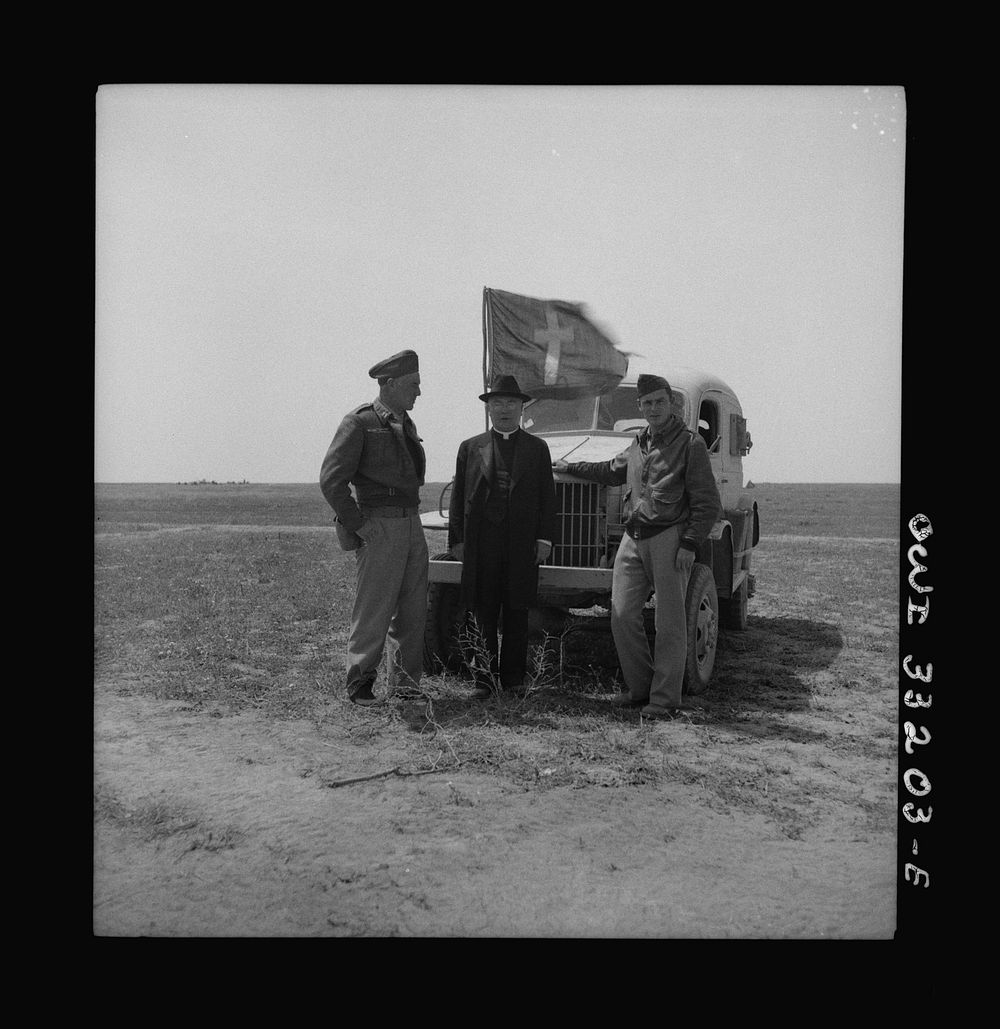 Archbishop Spellman of New York visiting with officers and men at 57th Fighter Group, Tunisia. Left to right: Captain J. E.…