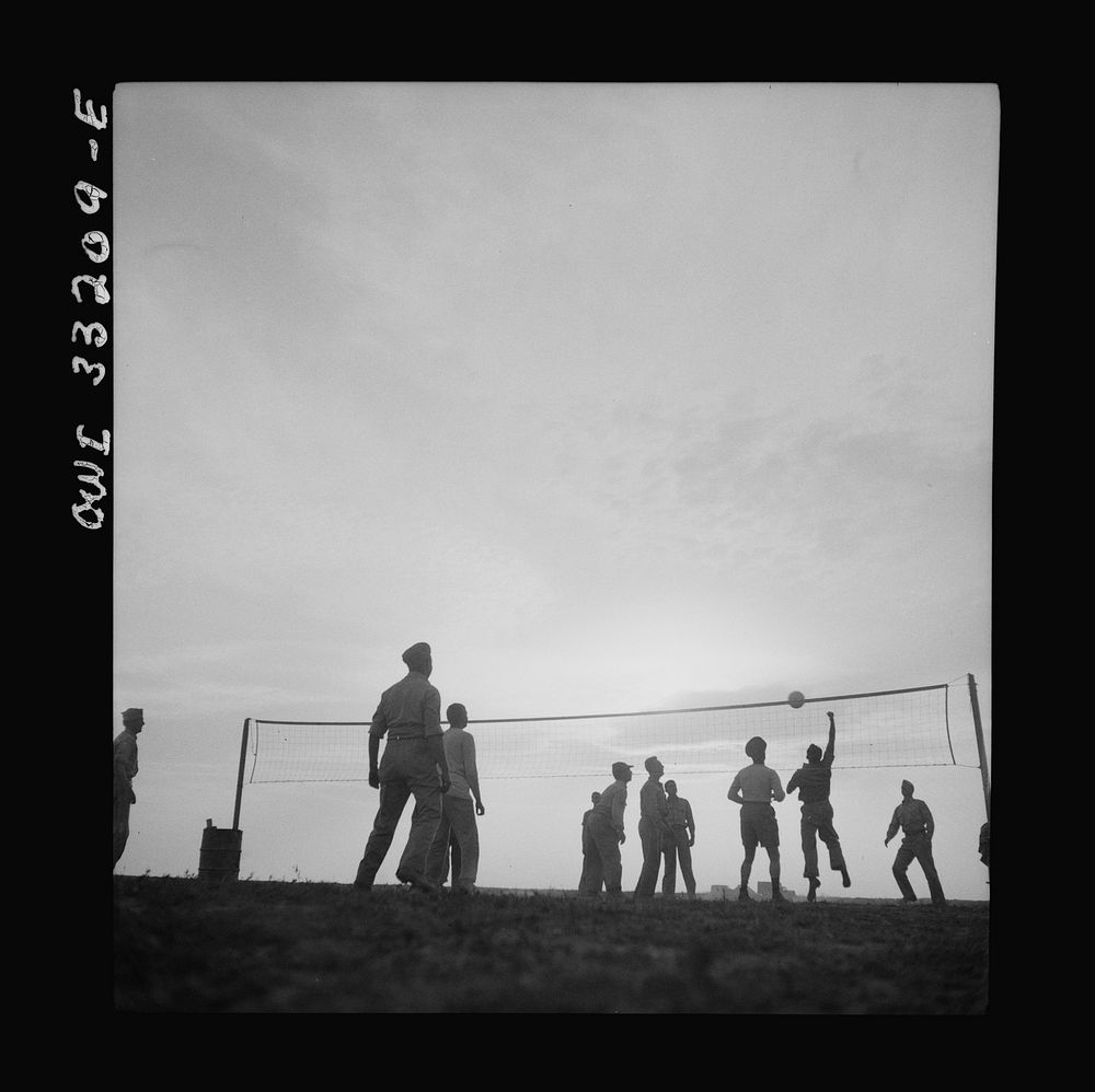 [Untitled photo, possibly related to: Men of the 57th Fighter Group relaxing with a game of volleyball somewhere in…