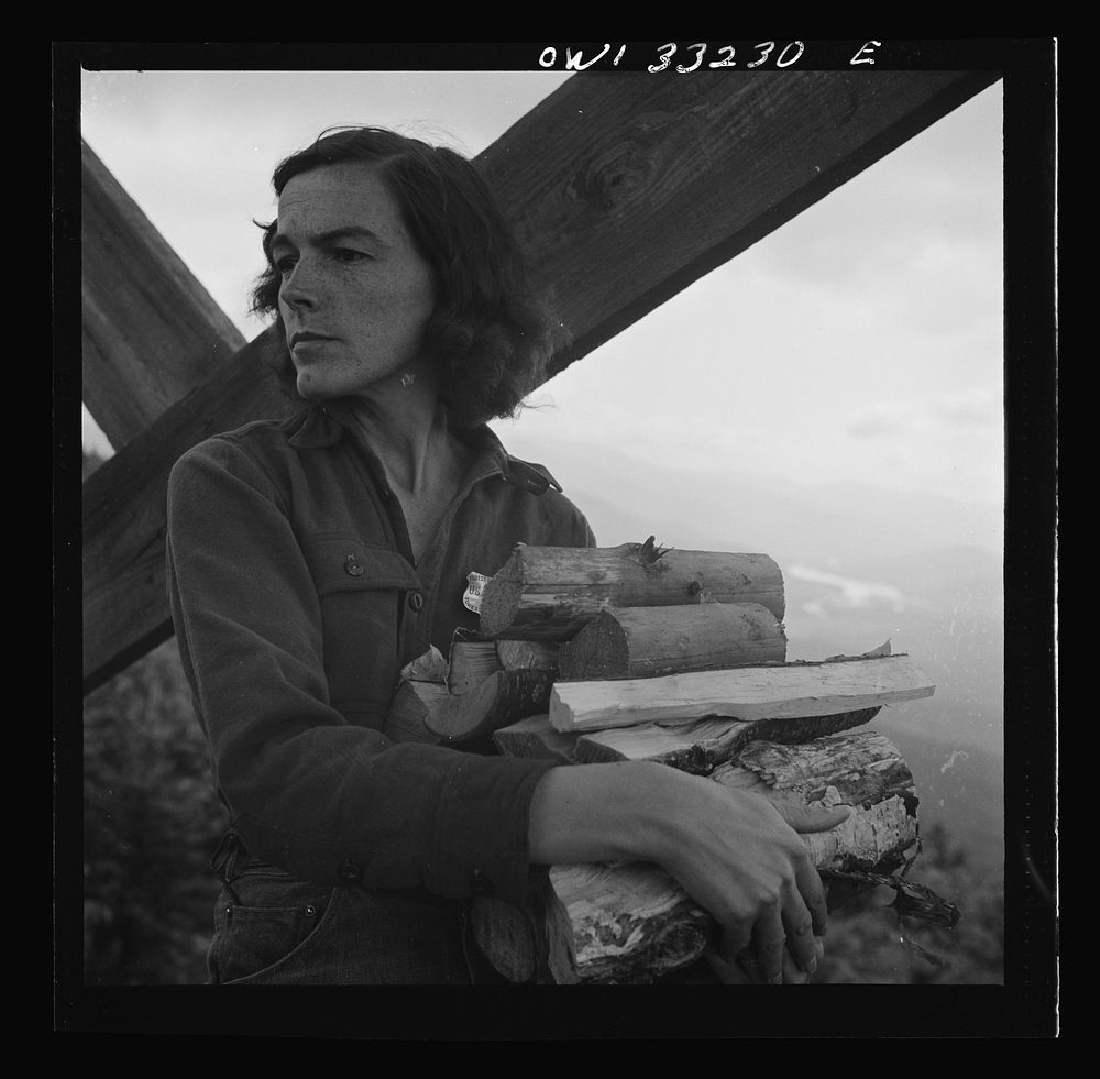 Gorham (vicinity), New Hampshire. Barbara Mortensen, a fire and airplane lookout on Pine Mountain. Carrying wood up fifty…