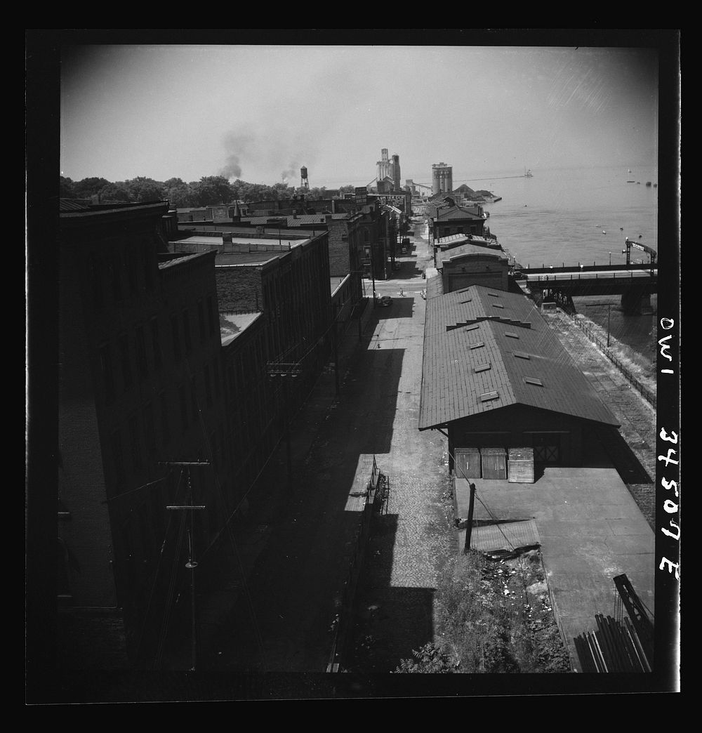 [Untitled photo, possibly related to: Oswego, New York. The waterfront looking toward Lake Ontario. A grain elevator is in…