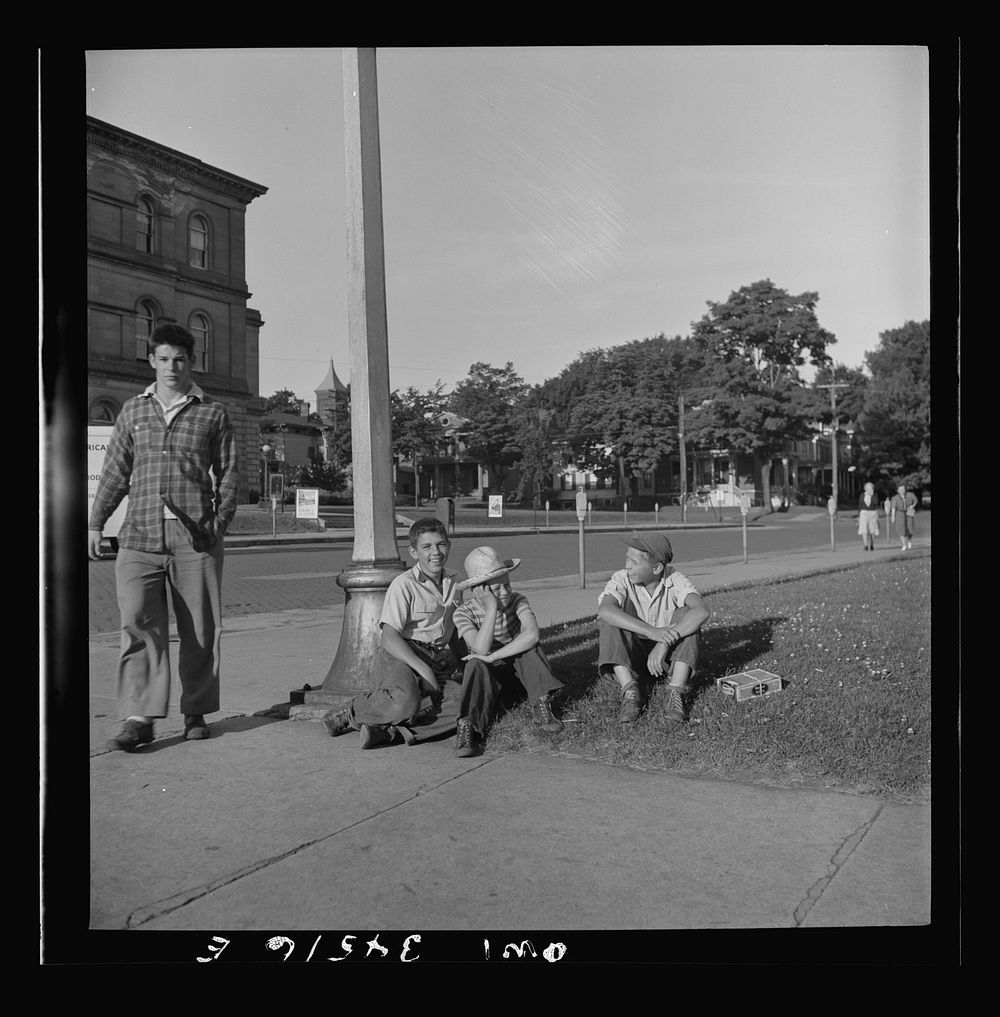 [Untitled photo, possibly related to: Oswego, New York. Boys recruited to work on the farms during the summer waiting to be…