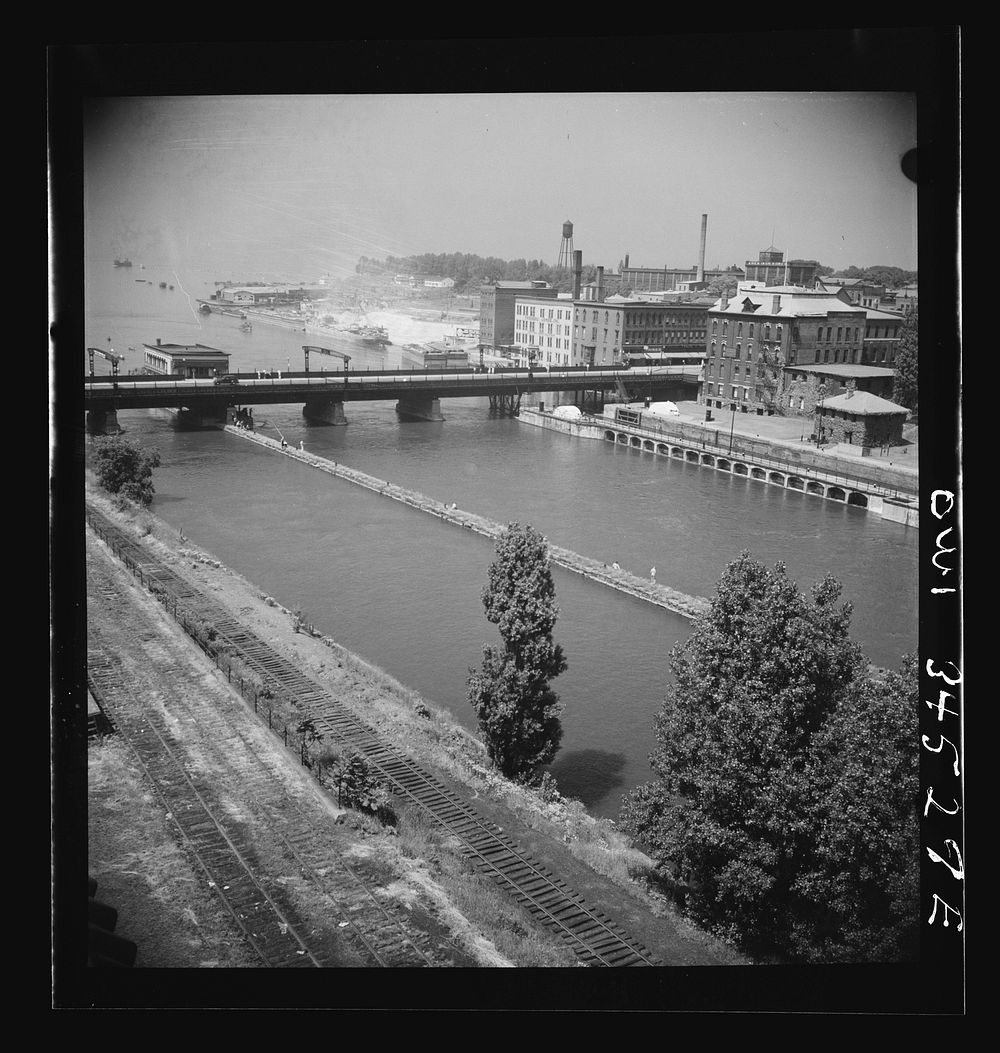 Oswego, New York. The Oswego River, looking toward Lake Ontario. Bauxite docks are on the far right. Sourced from the…