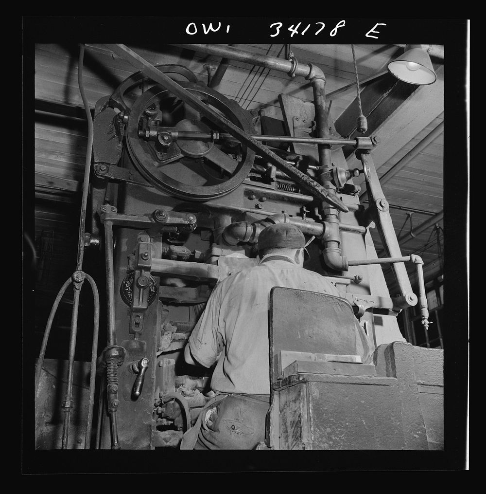[Untitled photo, possibly related to: New Britain, Connecticut A core blowing machine. Sand is blown into the core box as it…