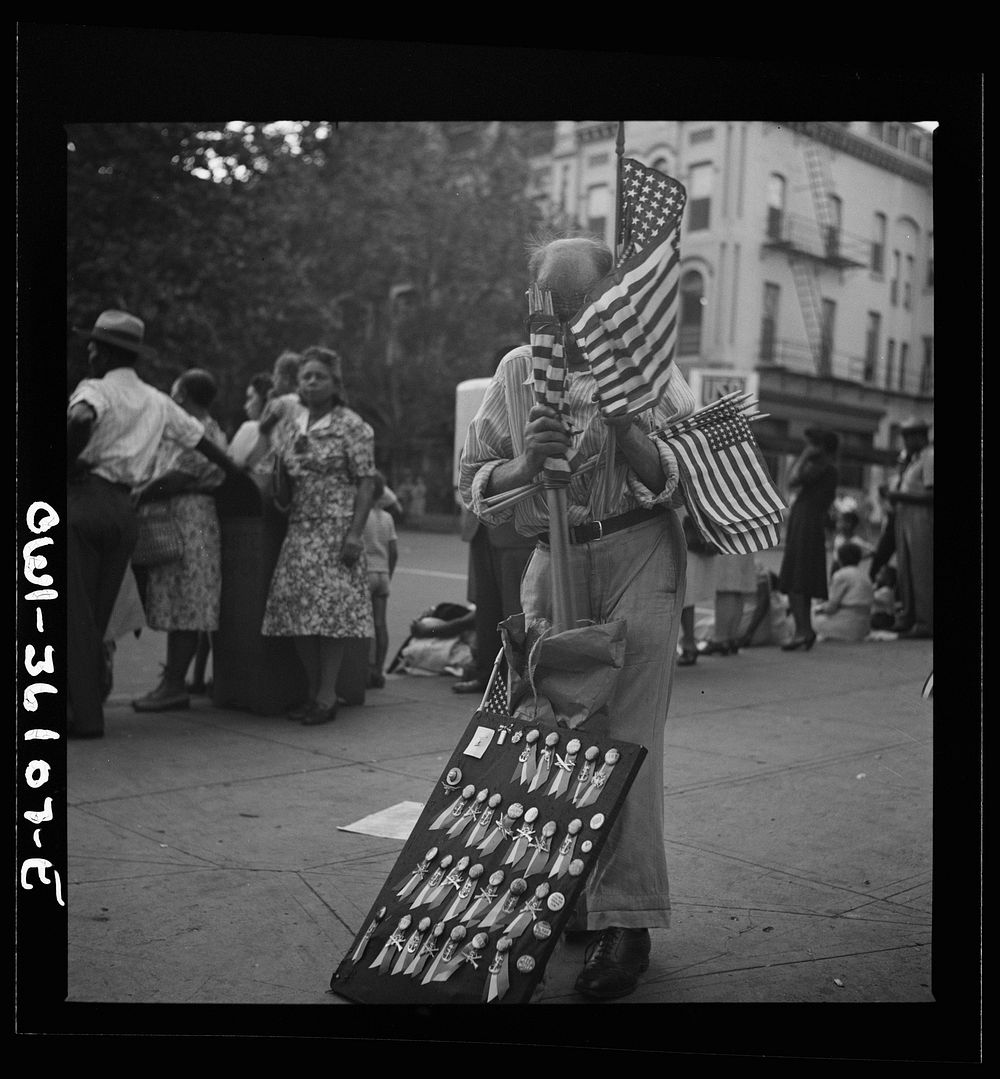 Washington, D.C. A man selling flags and buttons at the parade to recruit civilian defense volunteers. Sourced from the…