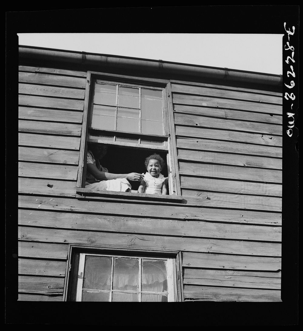 Washington, D.C. A child in her home, which is an alley dwelling near the capitol. Sourced from the Library of Congress.