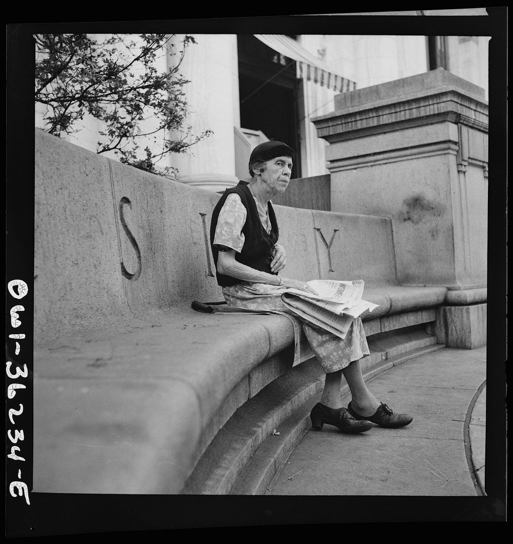 Washington, D.C. A woman sitting in front of a public library. Sourced from the Library of Congress.