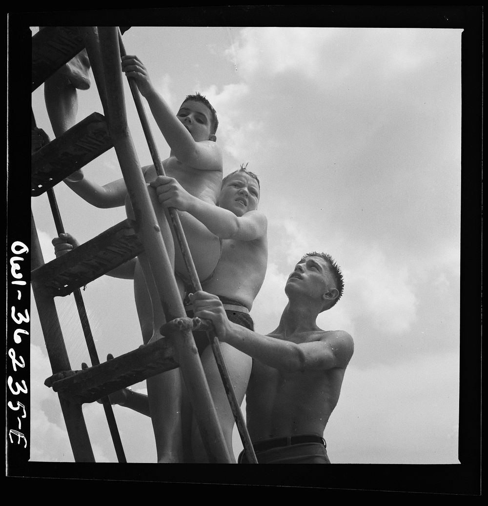 Glen Echo, Maryland. Climbing the ladder to the sliding board at the swimming pool. Sourced from the Library of Congress.