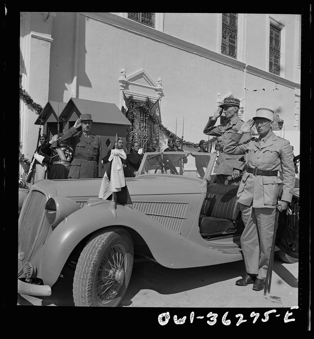 [Untitled photo, possibly related to: Carthage, Tunisia. General de Gaulle, accompanied by General Mast, saluting as the…