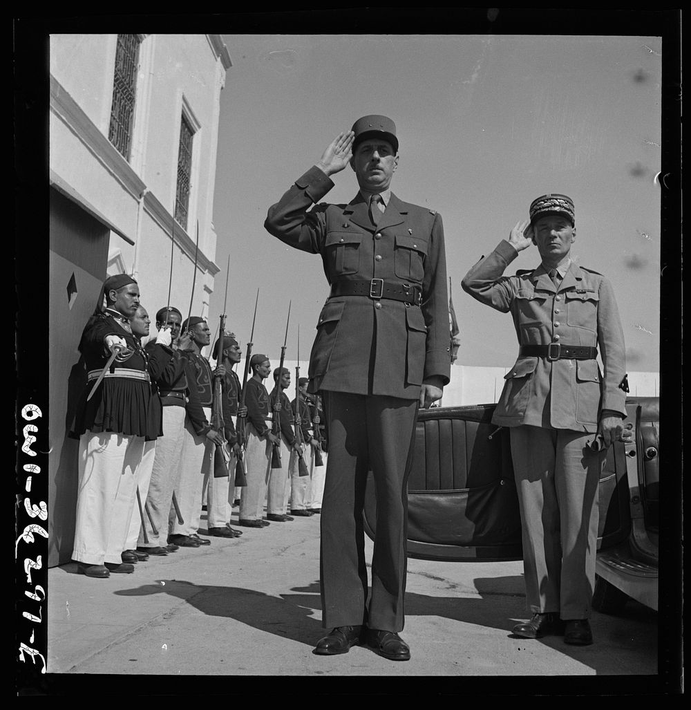 Carthage, Tunisia. General de Gaulle, accompanied by General Mast, saluting as the band plays Marseillaise outside the…