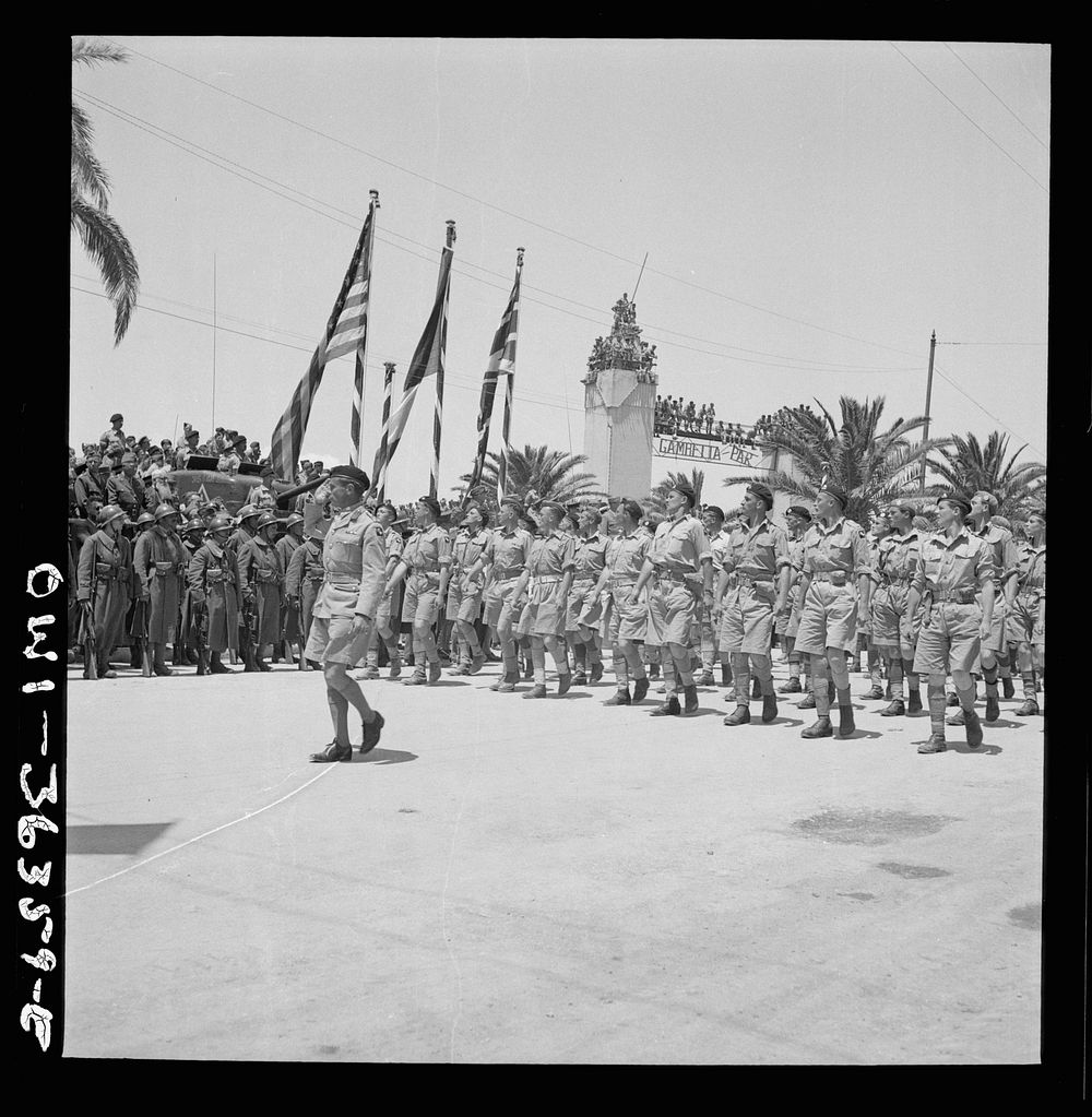 [Untitled photo, possibly related to: Tunis, Tunisia. French troops passing the reviewing stand in the Allied victory parade…