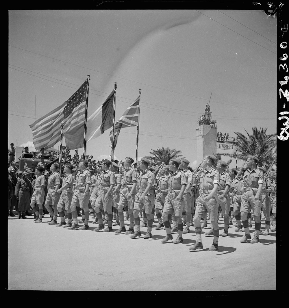 [Untitled photo, possibly related to: Tunis, Tunisia. French troops passing the reviewing stand in the Allied victory parade…