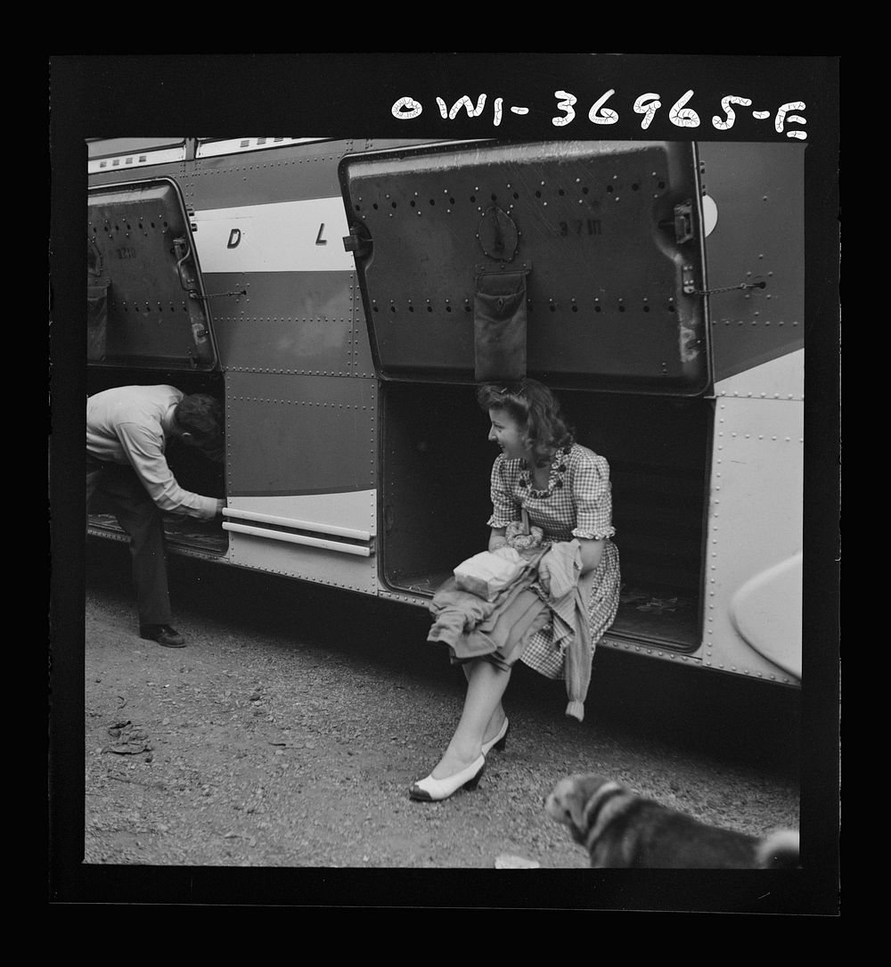 [Untitled photo, possibly related to: A girl passenger sitting in a baggage compartment while she is waiting for the driver…