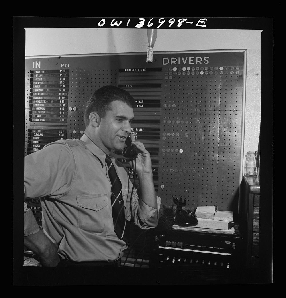 [Untitled photo, possibly related to: Pittsburgh, Pennsylvania. Dispatcher at the Greyhound garage. The board in the…