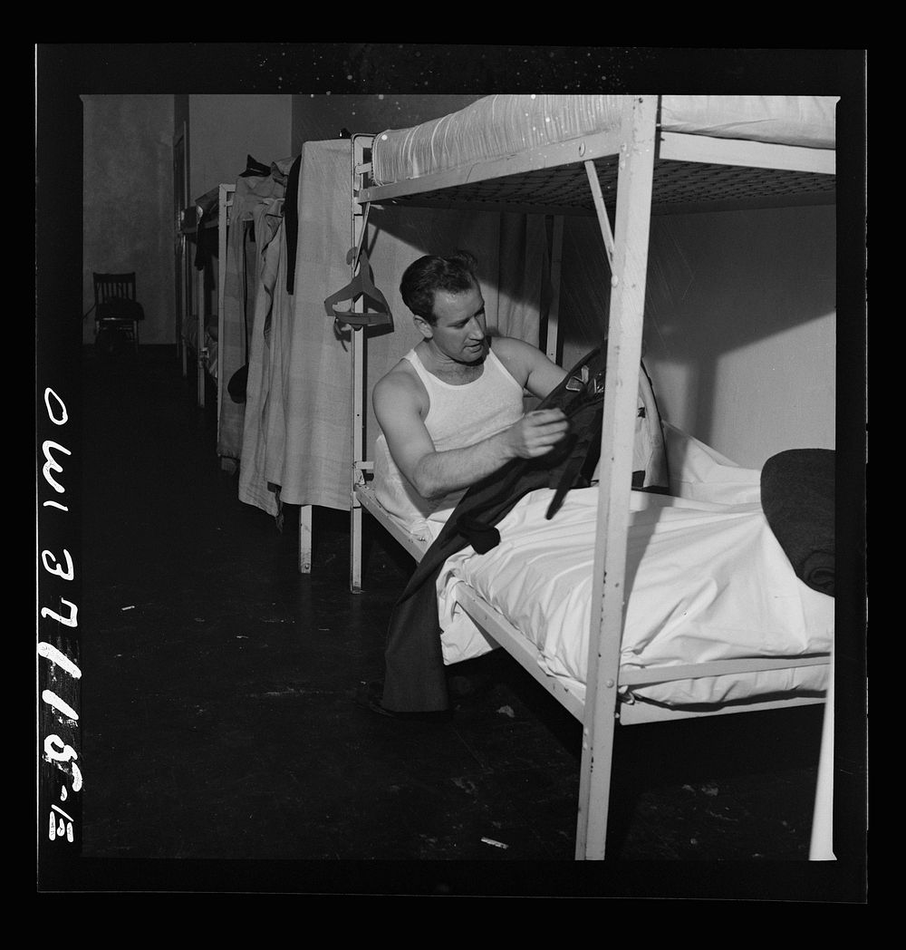 A Greyhound bus driver dressing in the dormitory at the garage. This is for the use of drivers living in another town but…