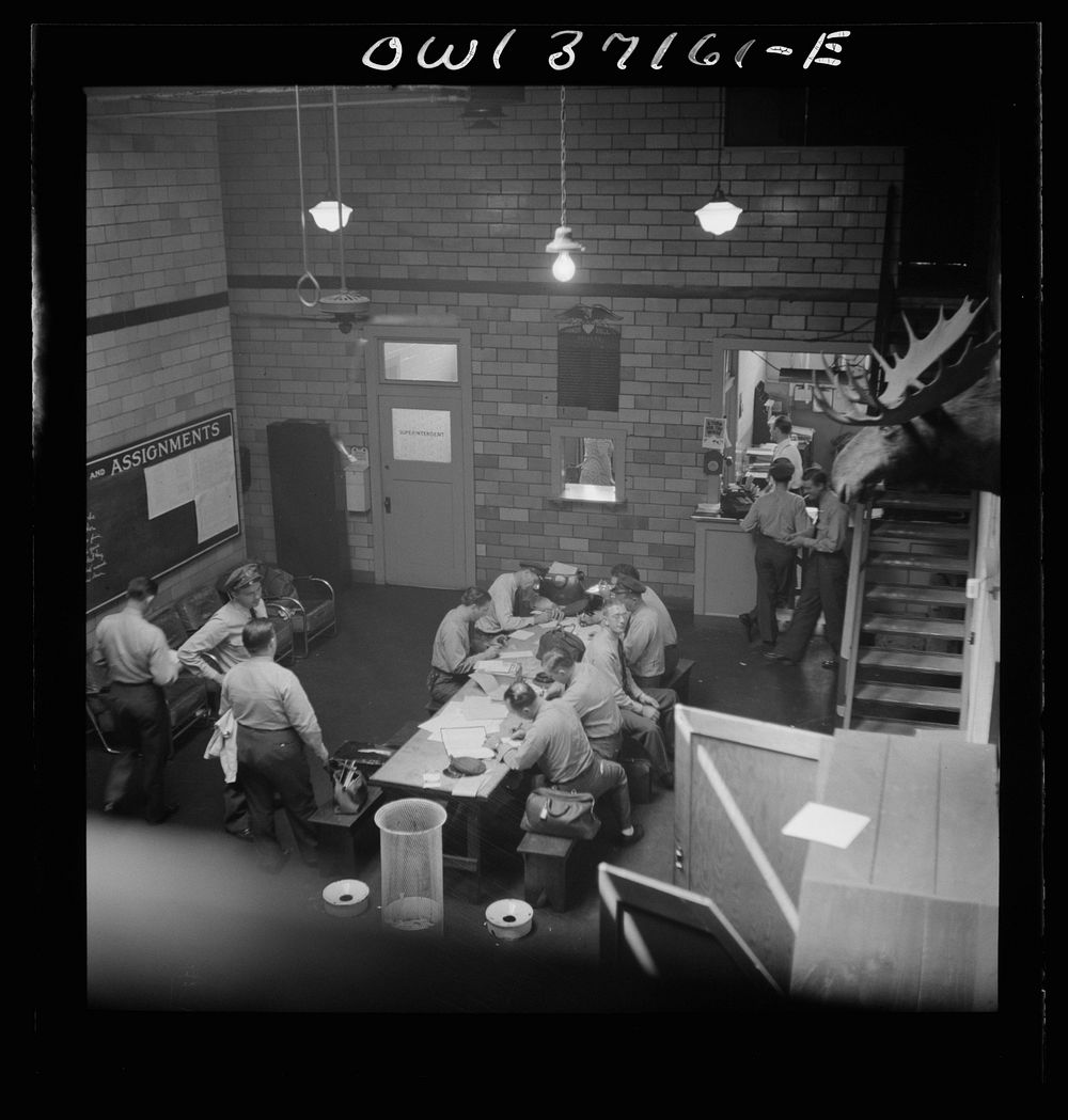 [Untitled photo, possibly related to: Pittsburgh, Pennsylvania. Greyhound bus drivers writing out trip reports in the…