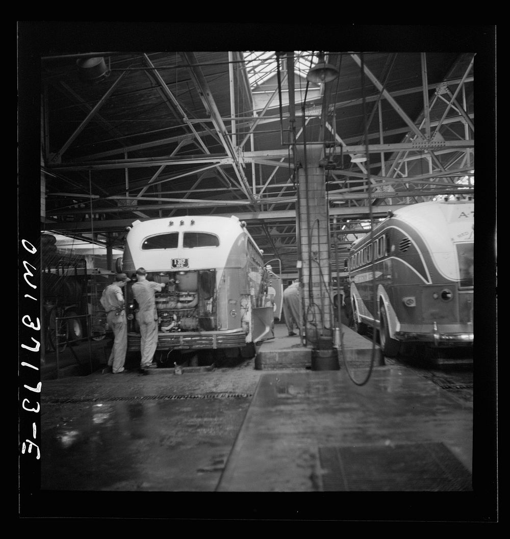 [Untitled photo, possibly related to: Pittsburgh, Pennsylvania. Some Greyhound buses which are placed over pits for repairs…