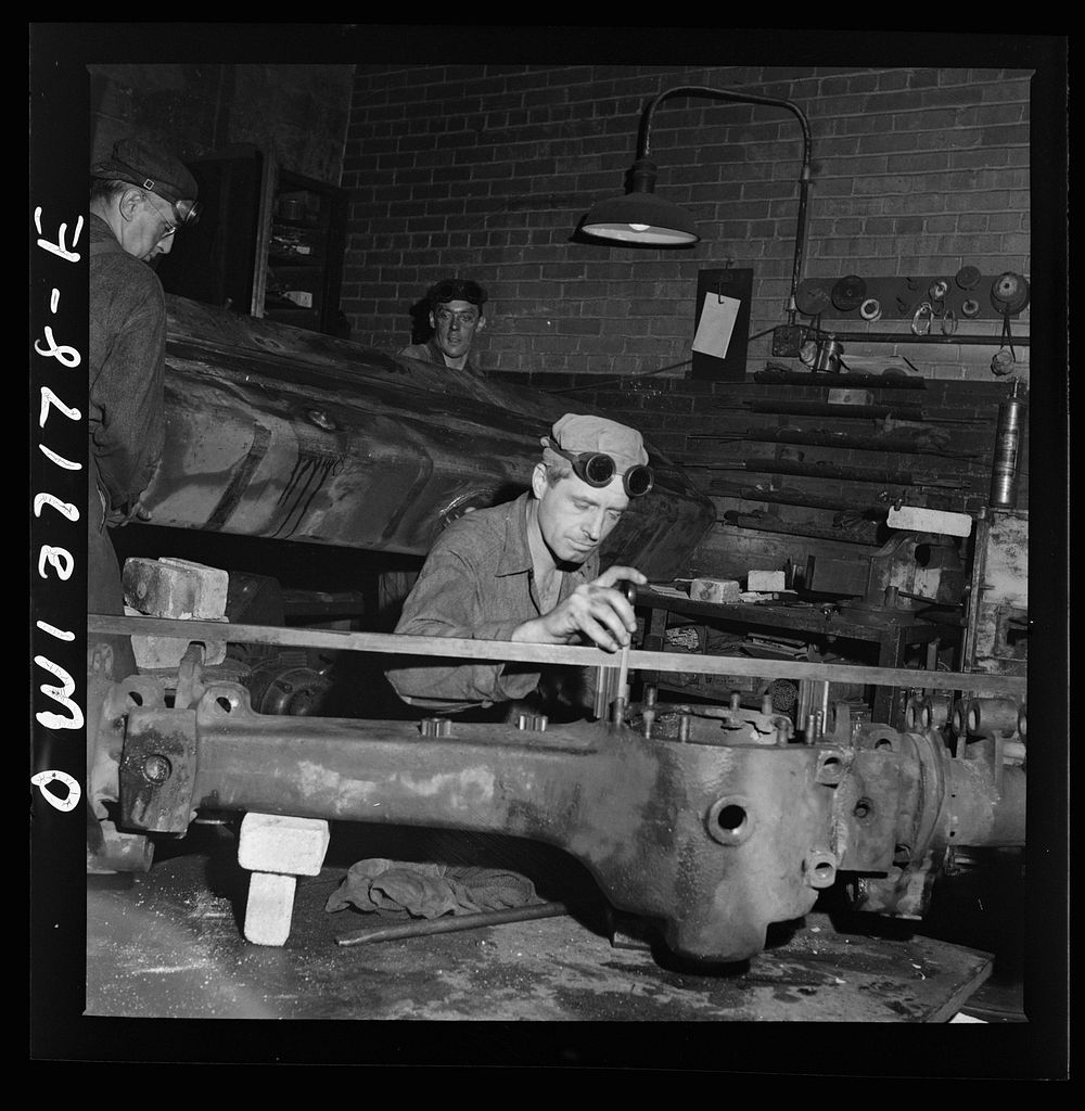 Pittsburgh, Pennsylvania. A mechanic working on a rear axle housing at the Greyhound garage. Sourced from the Library of…