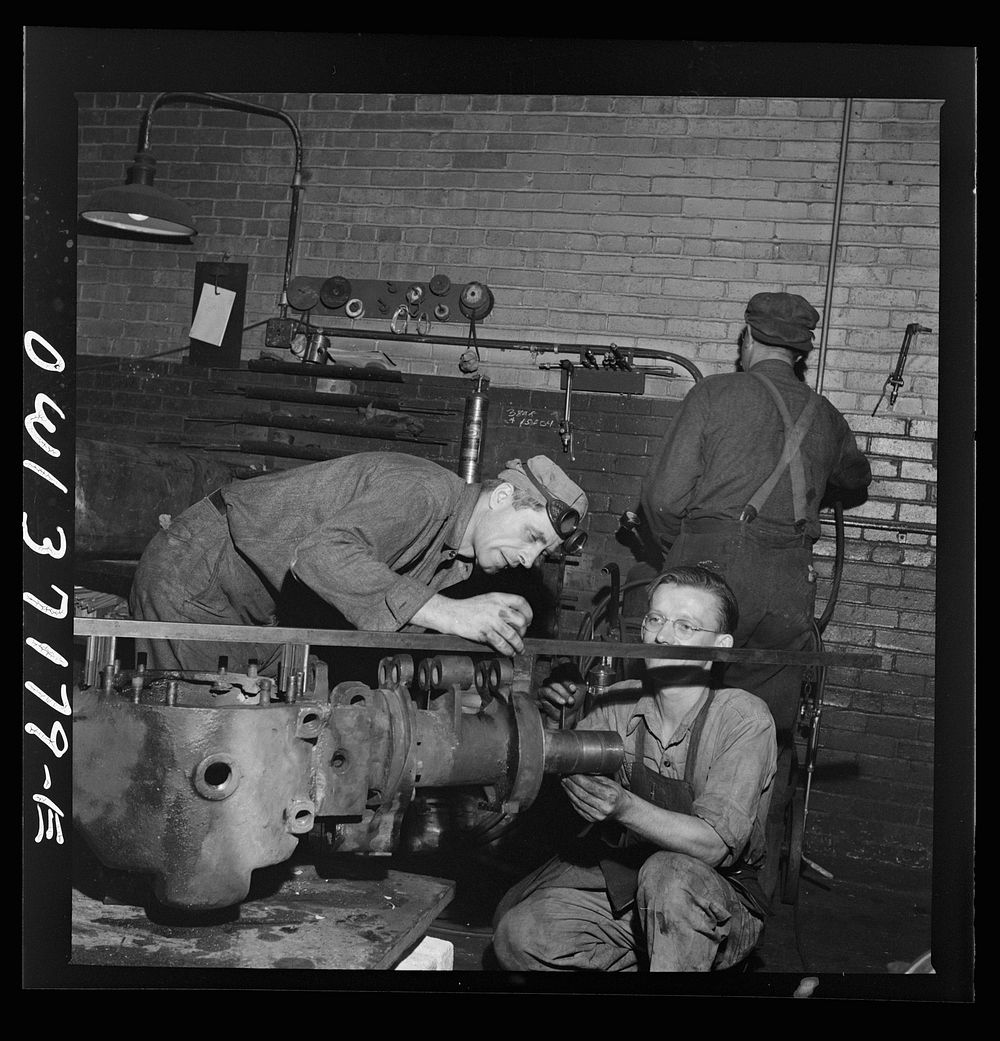 Pittsburgh, Pennsylvania. A mechanic working on a rear axle housing at the Greyhound garage. Sourced from the Library of…