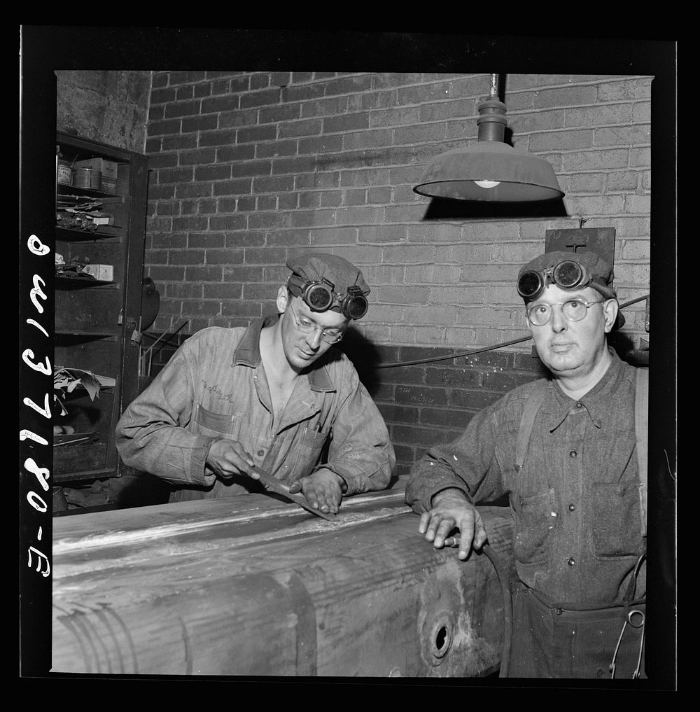 A mechanic working on a gas tank at the Greyhound garage. Sourced from the Library of Congress.