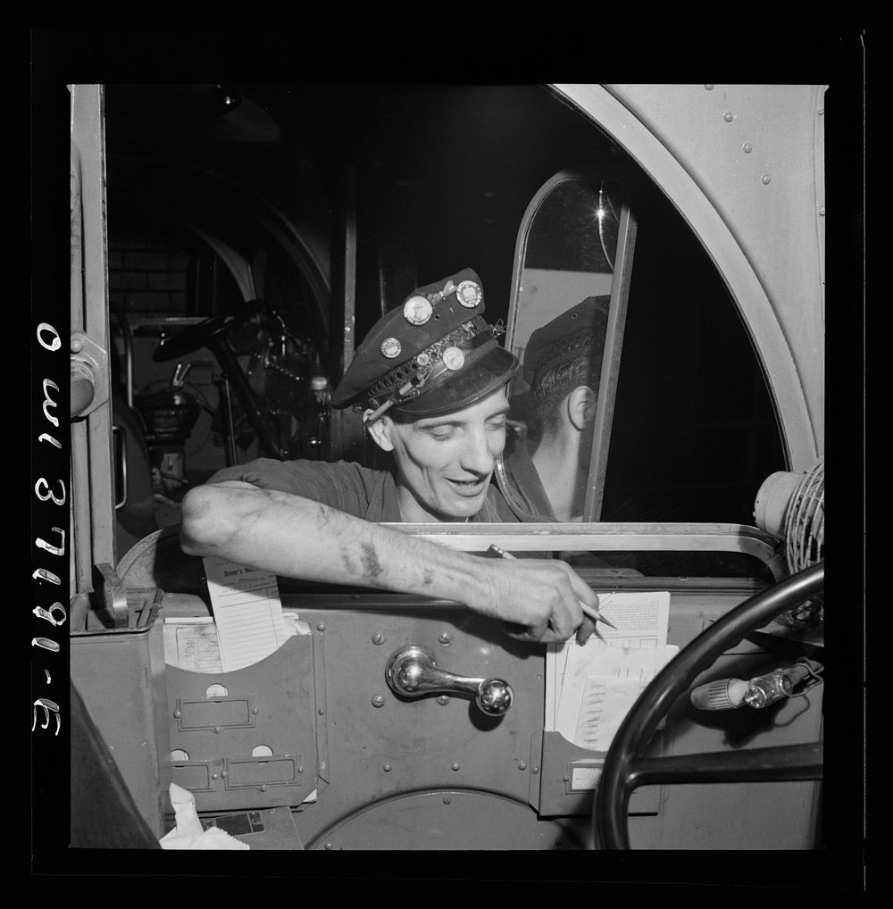 Pittsburgh, Pennsylvania. A worker taking a card from a bus to record the amount of gas it will get at the Greyhound garage.…