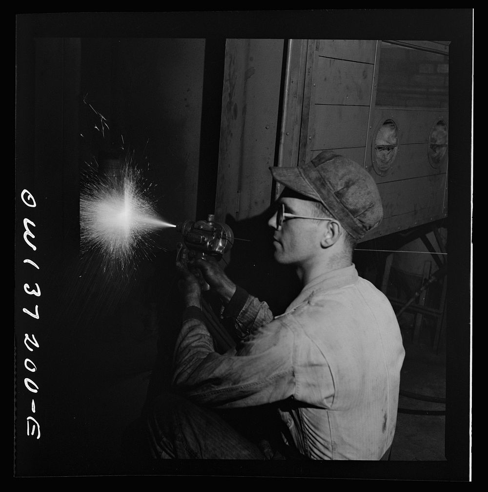 [Untitled photo, possibly related to: Pittsburgh, Pennsylvania. A mechanic metalizing a part in the machine shop at the…