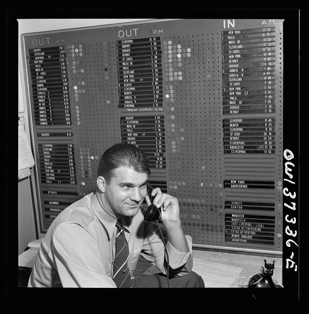 Pittsburgh, Pennsylvania. Dispatcher at the Greyhound garage. The board in the background shows drivers and equipment…