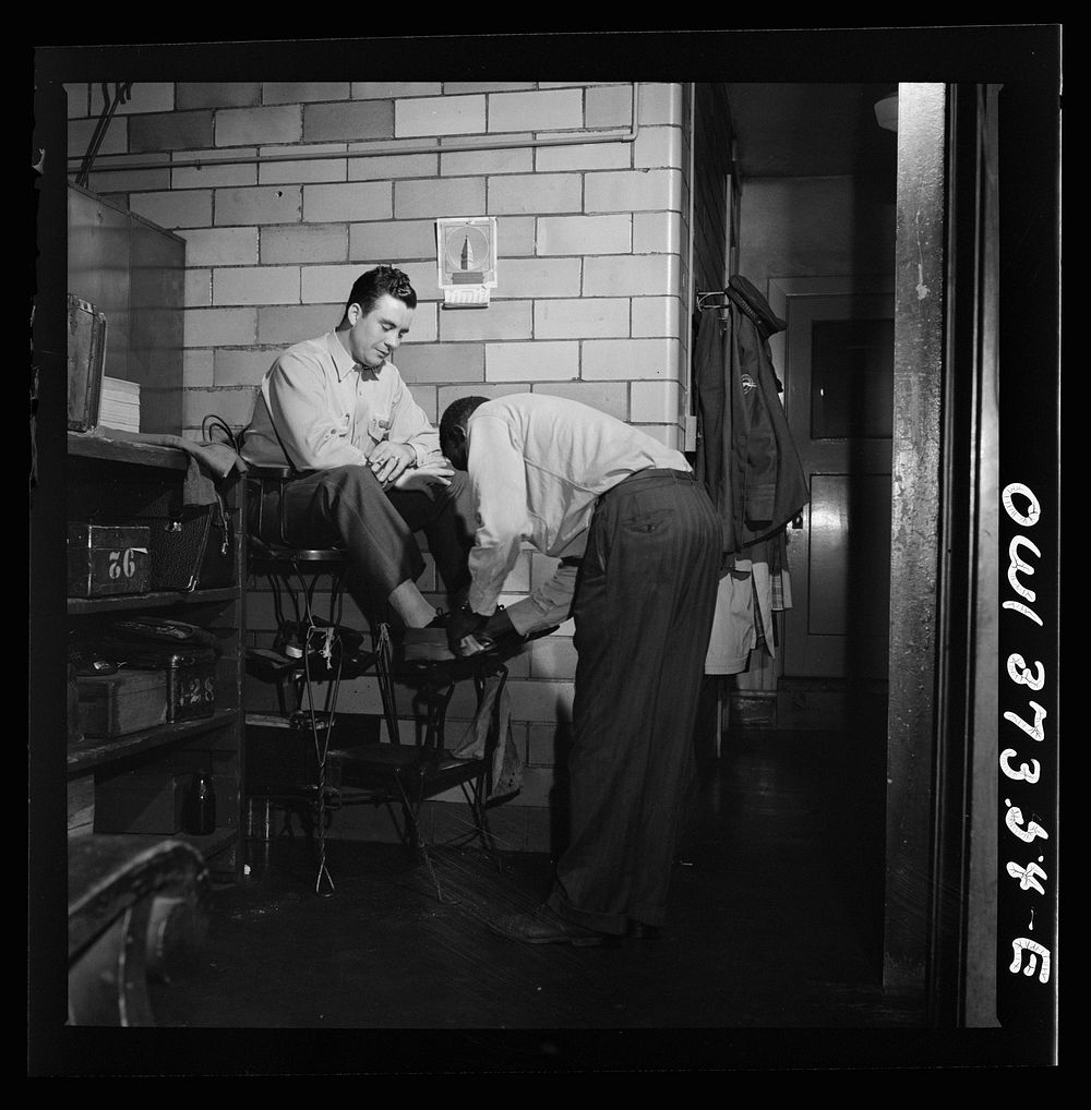[Untitled photo, possibly related to: Pittsburgh, Pennsylvania. A Greyhound driver getting his shoes shined by a porter at…