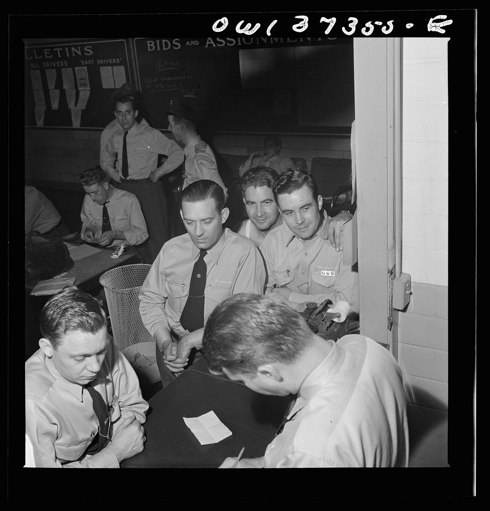Pittsburgh, Pennsylvania. Greyhound bus drivers getting their assignments at the dispatcher's desk in the garage. Sourced…