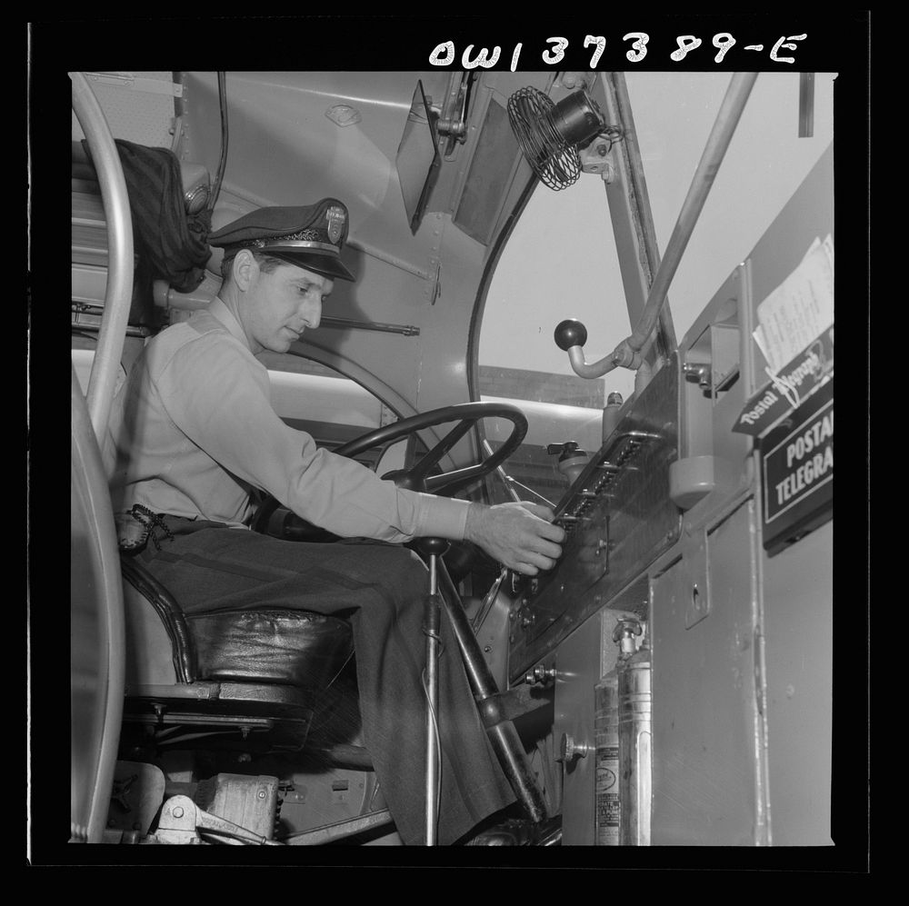 Columbus, Ohio. Randy Pribble, a driver for the Pennsylvania Greyhound Lines, Incorporated, checking the lights on a bus…