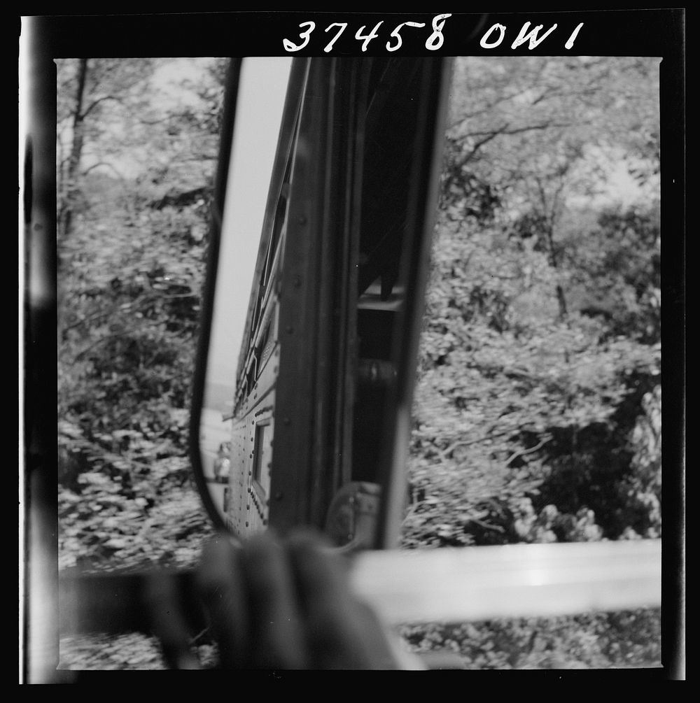 Looking through the windshield and into the rear-view mirror during a bus trip from Columbus to Cincinnati, Ohio. Sourced…