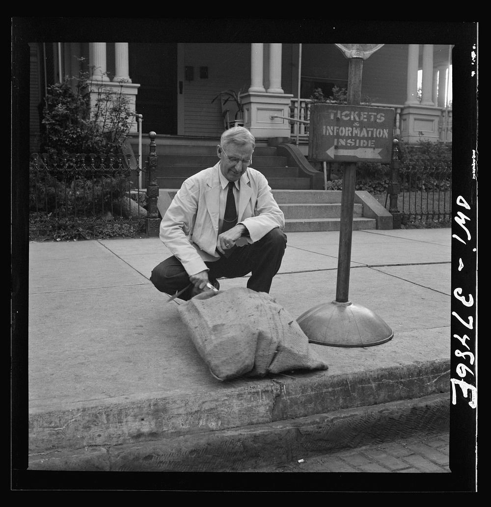 Washington Court House, Ohio. A ticket agent inspecting some freight left by bus. Sourced from the Library of Congress.