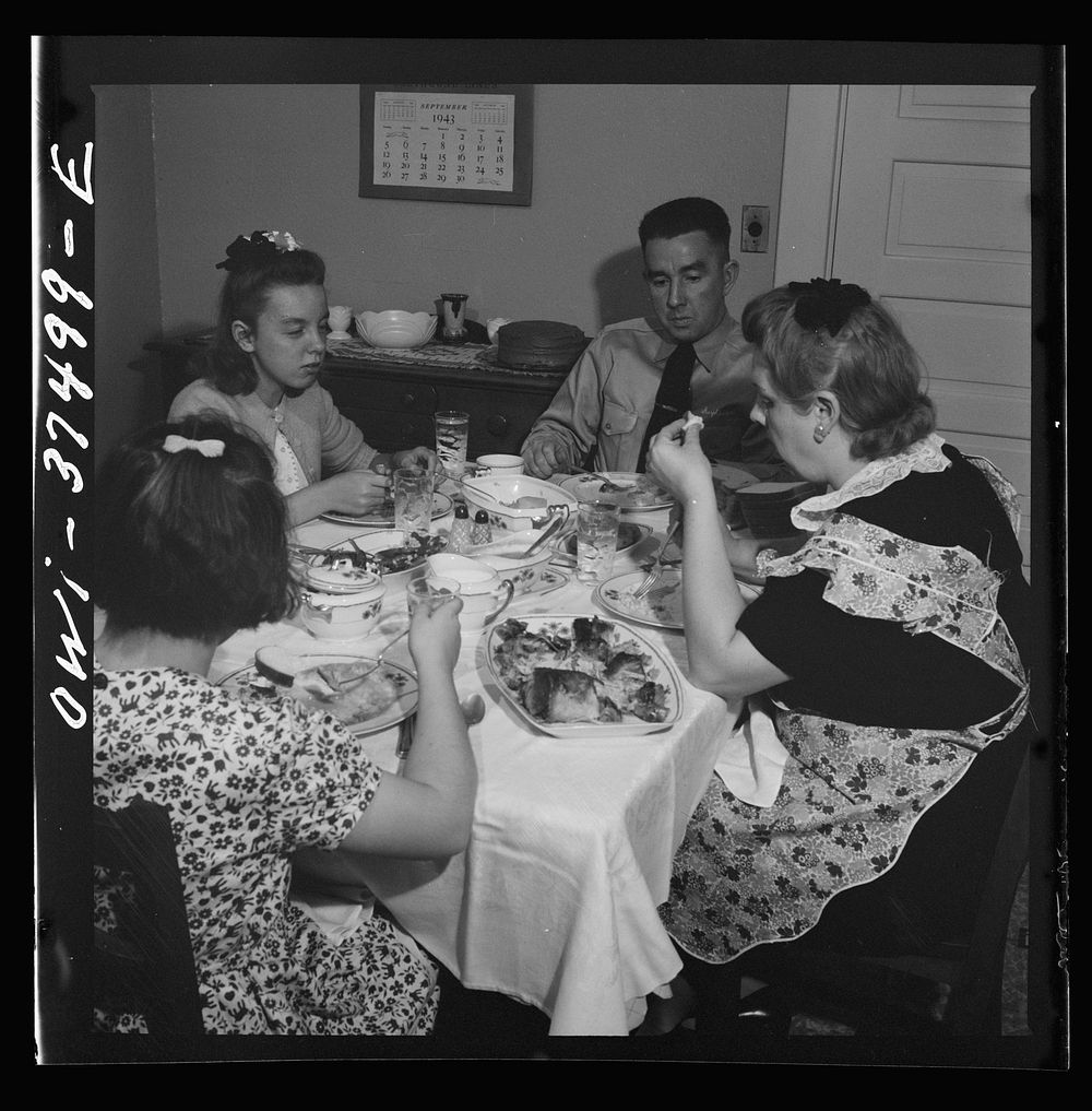 Cincinnati, Ohio. "Red" Cochran, a Greyhound bus driver and his family having Sunday dinner. Sourced from the Library of…