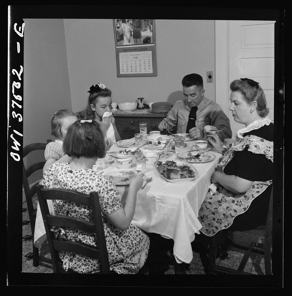 Cincinnati, Ohio. "Red" Cochran, a Greyhound bus driver, and his family eating Sunday dinner. Sourced from the Library of…