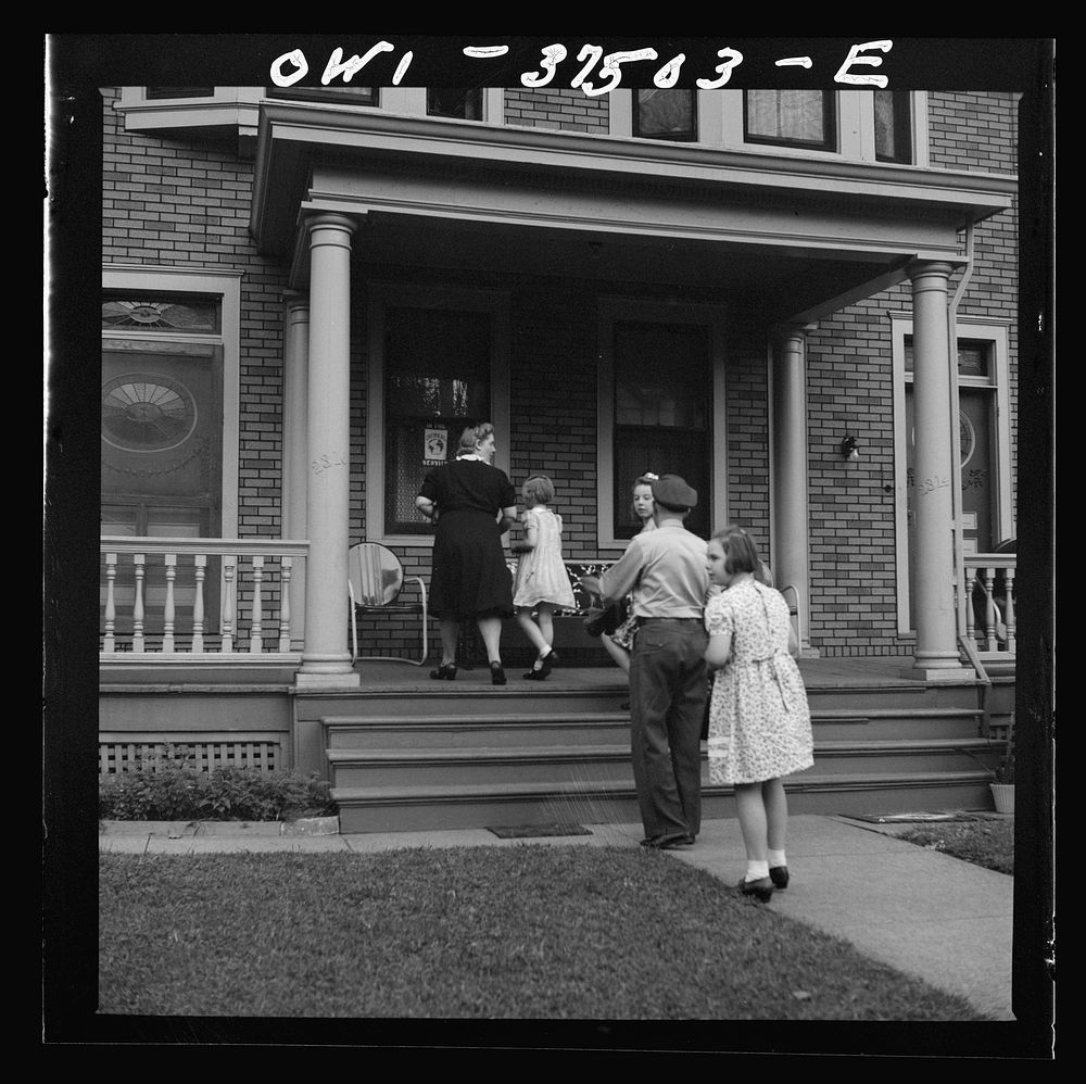 Cincinnati, Ohio. Bernard Cochran, a Greyhound bus driver, going into the house with his family. His wife and children drive…