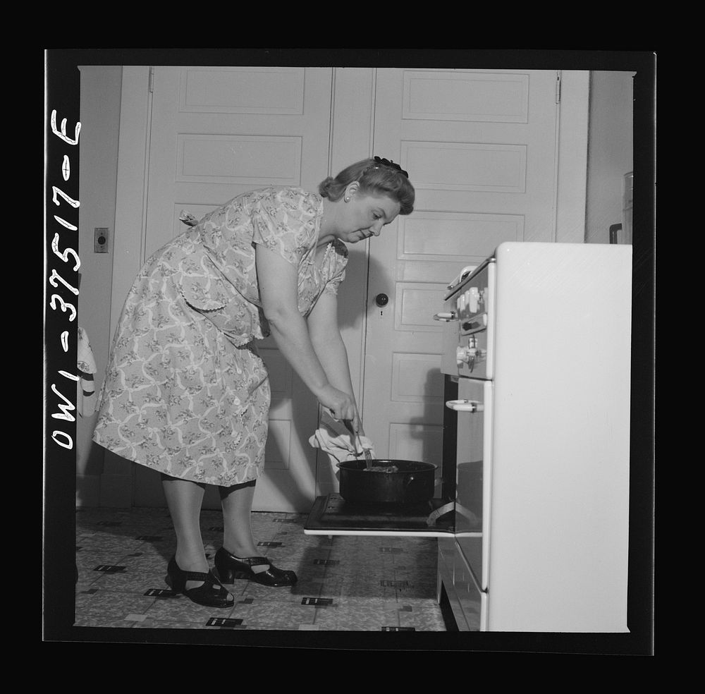 Cincinnati, Ohio. Mrs. Bernard Cochran, wife of a Greyhound bus driver, turning the Sunday roast. Sourced from the Library…