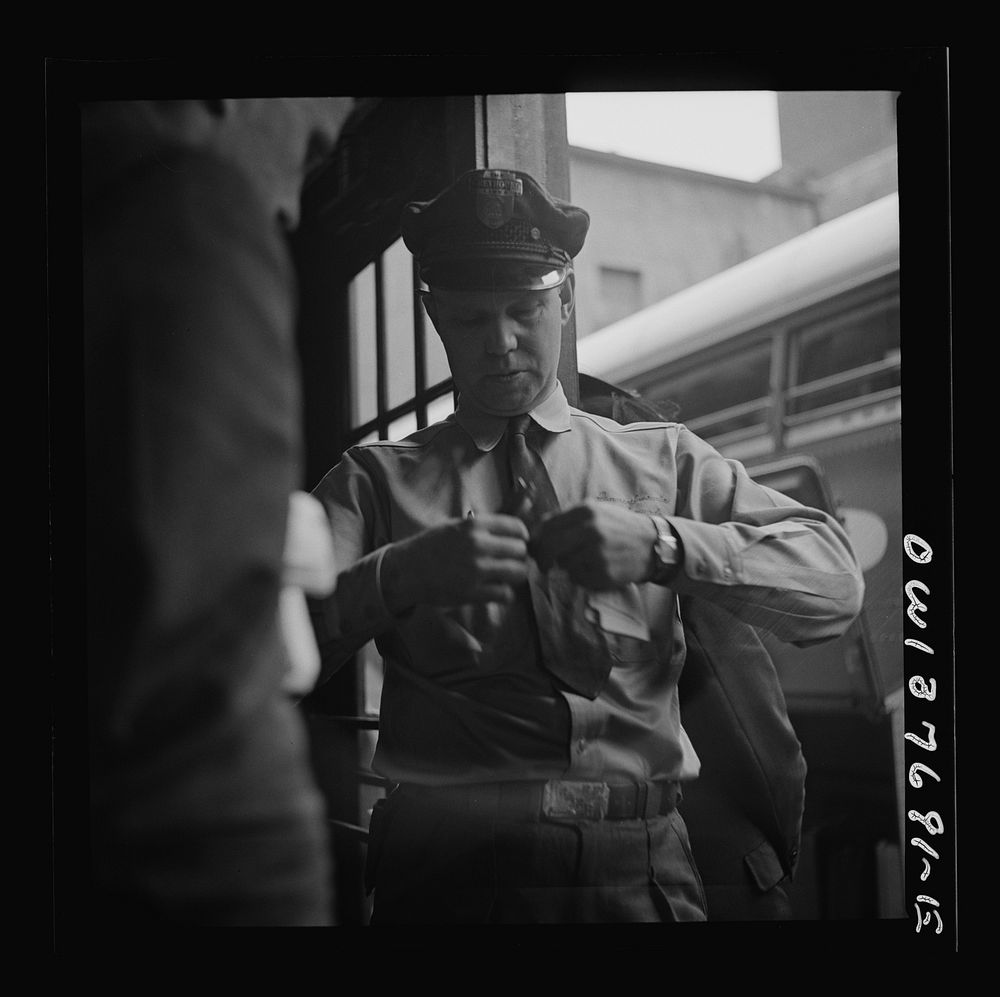 Chicago, Illinois. A bus driver punching tickets. Sourced from the Library of Congress.