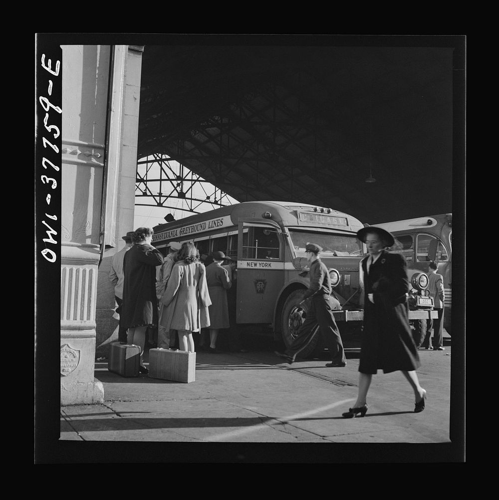 Indianapolis, Indiana. An old-type bus being boarded by passengers in the Greyhound bus terminal. The drivers call this type…