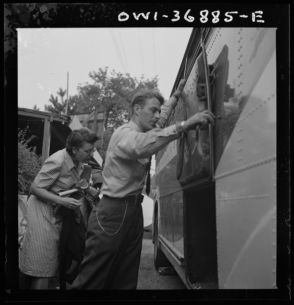 A driver getting ready to transfer the baggage from a Greyhound bus, which has broken down, to another bus in a small town…