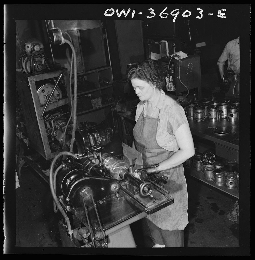 Pittsburgh, Pennsylvania. One of the women employees in the machine shop of the Greyhound garage working on a cylinder…