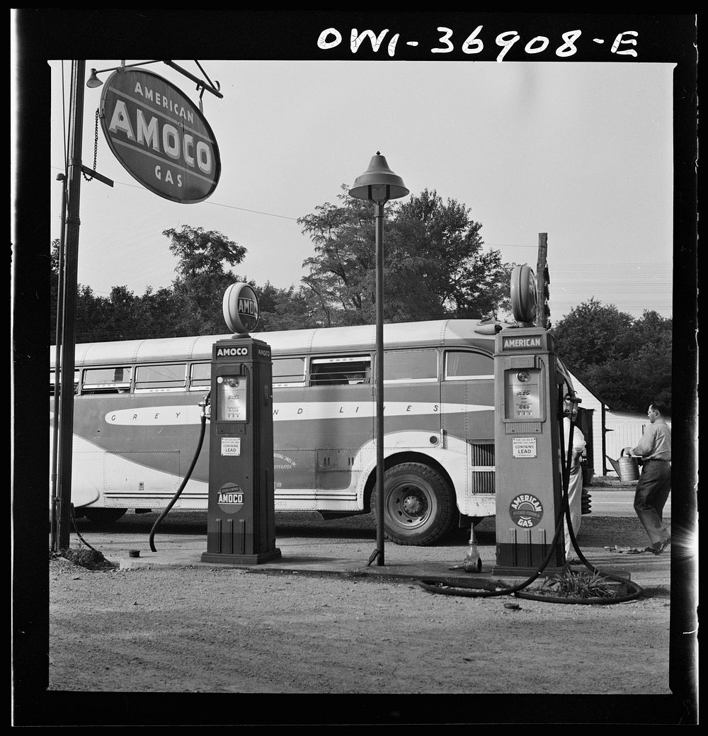 A Greyhound bus that has been stopped while the driver fills the water tank at a gas station on the road between Gettysburg…