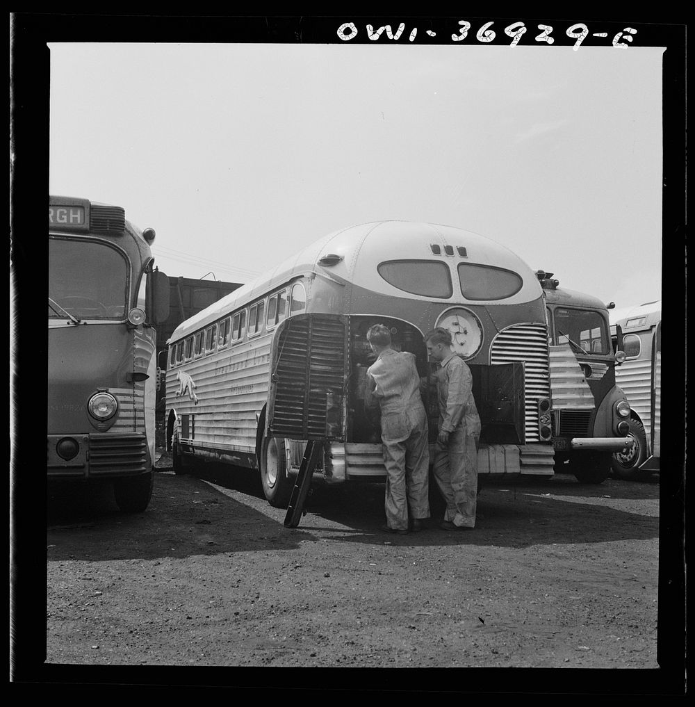 Pittsburgh, Pennsylvania. Mechanics working on a bus parked outside the Greyhound garage because there is no room inside.…
