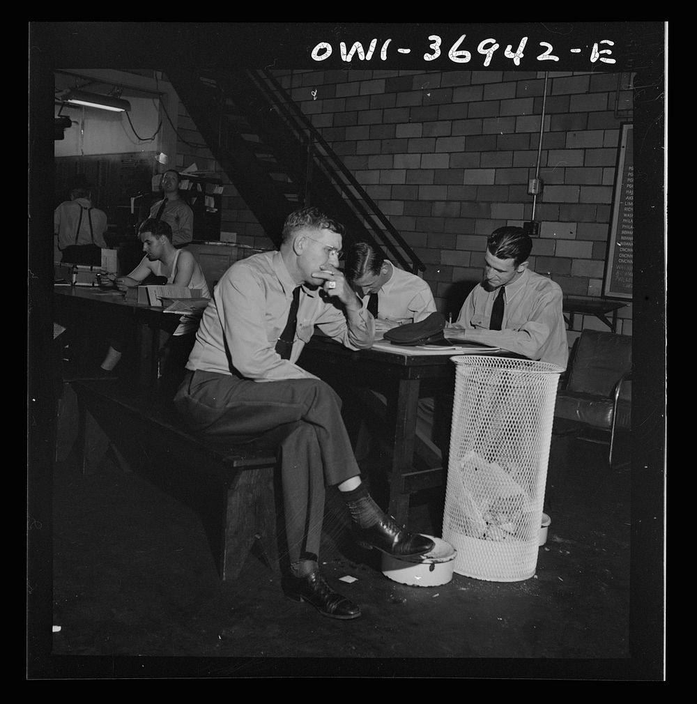 [Untitled photo, possibly related to: Pittsburgh, Pennsylvania. Greyhound bus drivers writing out trip reports in the…