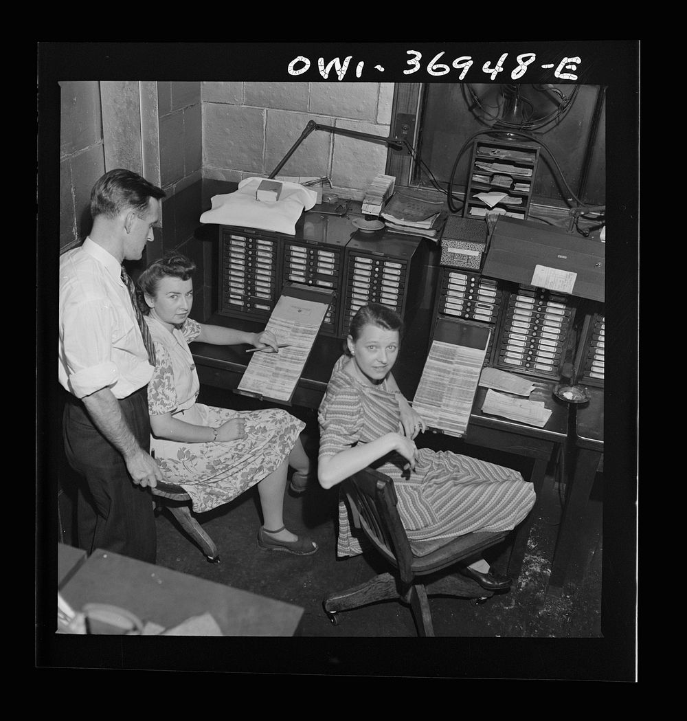 Pittsburgh, Pennsylvania. Part of the office staff with the card system which lists parts in the Greyhound garage. Sourced…