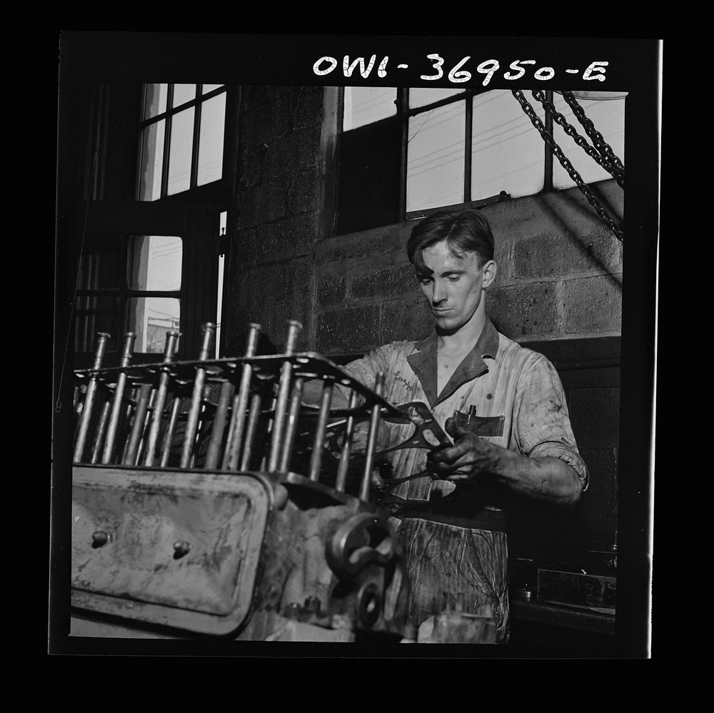 Pittsburgh, Pennsylvania. Mechanic working on a bus engine at the garage. Sourced from the Library of Congress.