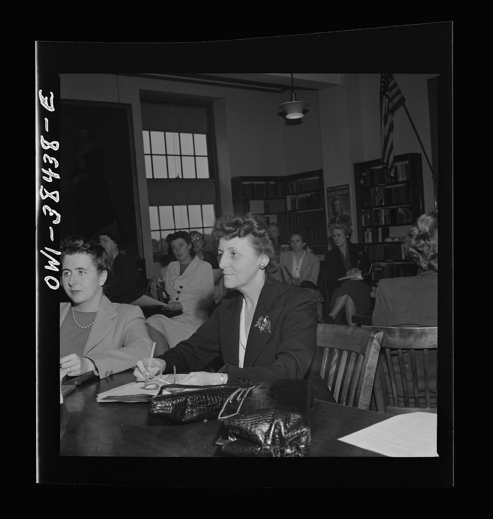 Washington, D.C. Mrs. Mary Spangler, English teacher, listening to instructions for distribution of ration books at the…