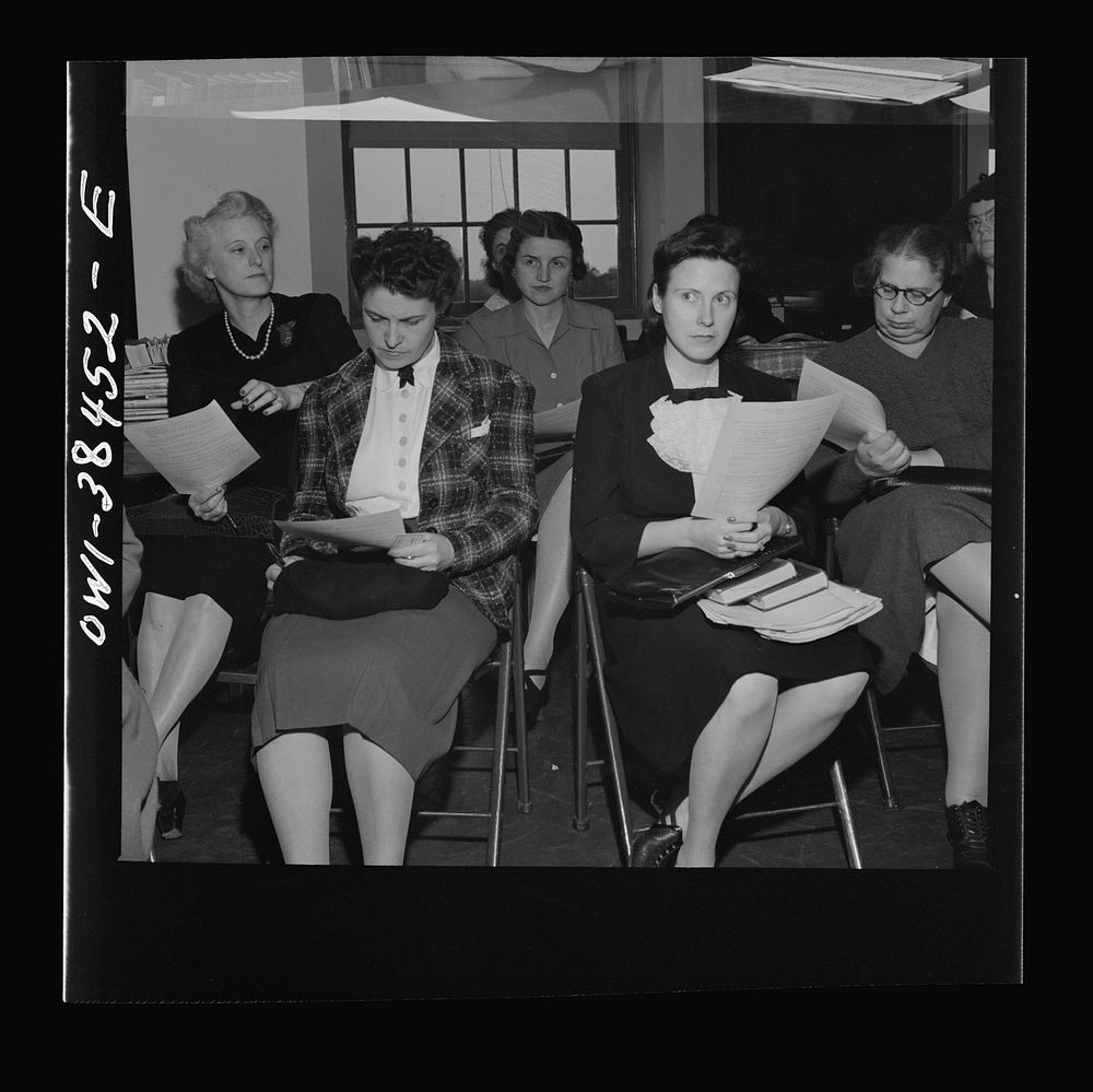 Washington, D.C. Teachers listening to instructions for giving out ration book no. 4 at Woodrow Wilson High School. Sourced…