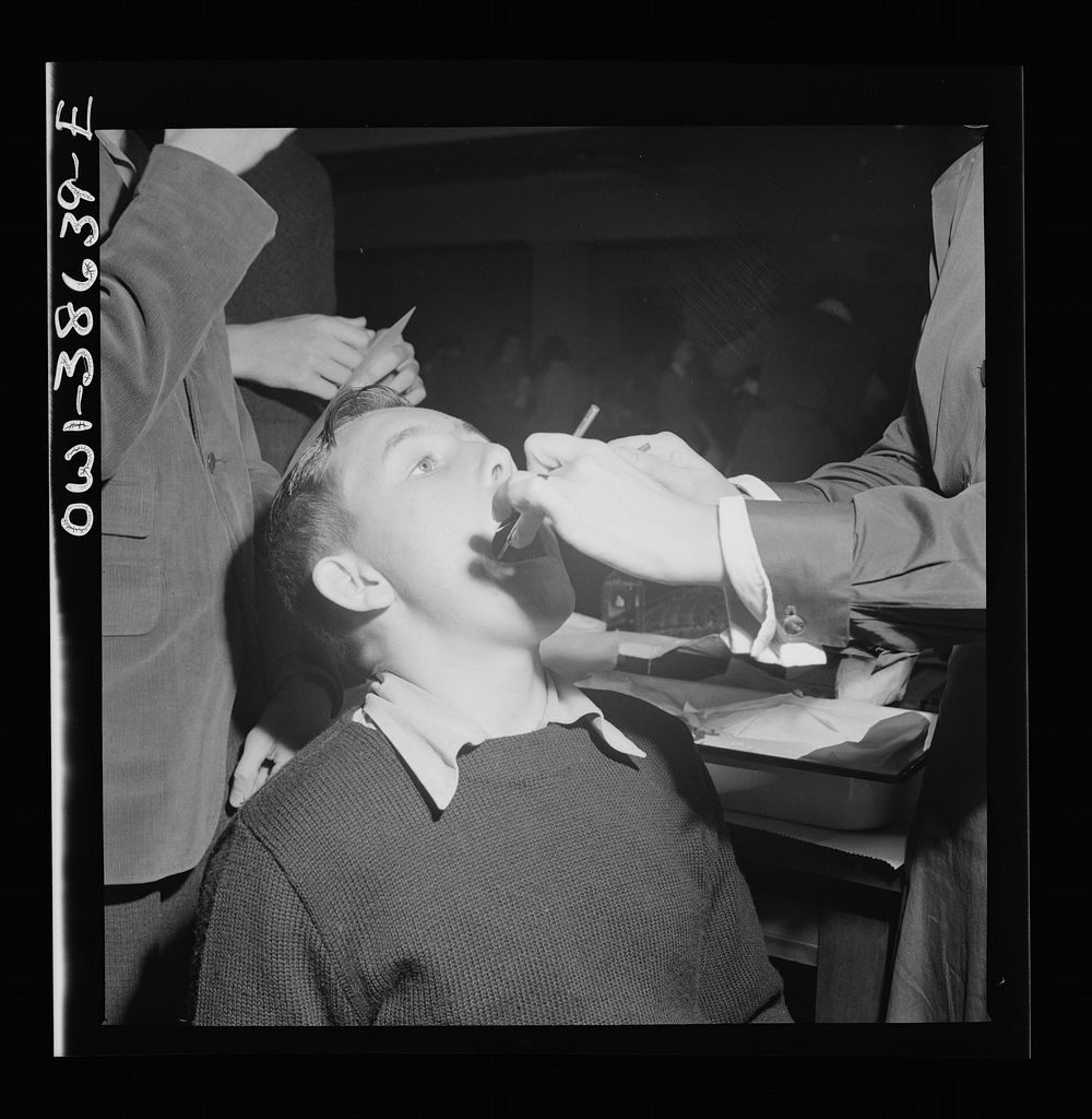 Washington, D.C. Student having his teeth examined an annual procedure at Wilson High School. Sourced from the Library of…