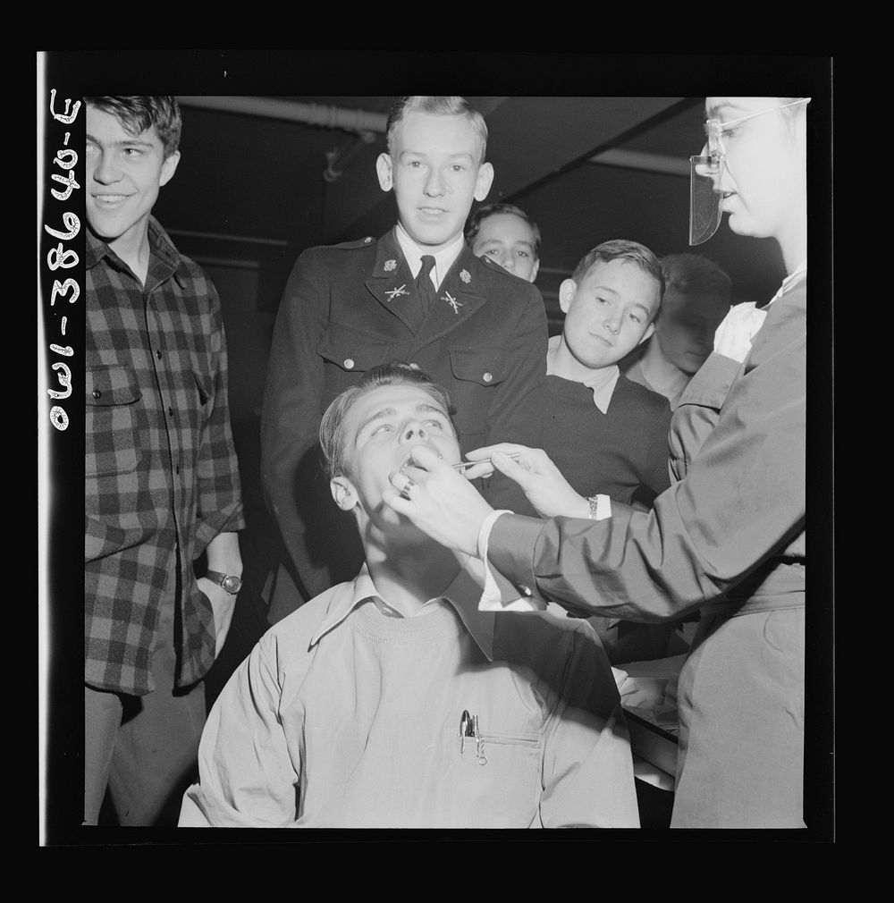 Washington, D.C. Student having his teeth examined an annual procedure at Wilson High School. Sourced from the Library of…
