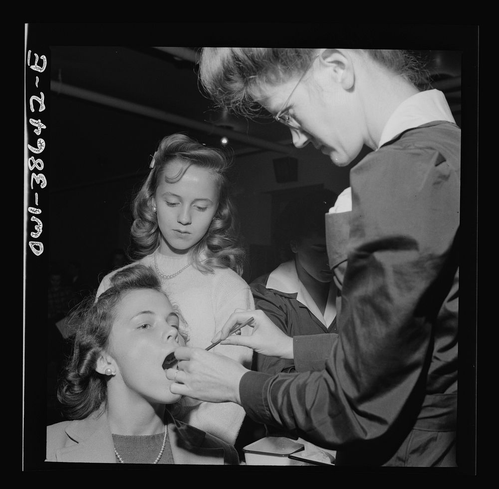 Washington, D.C. Student having her teeth examined, an annual procedure at Wilson High School. Sourced from the Library of…